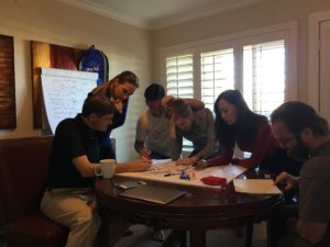 Group of people writing at table